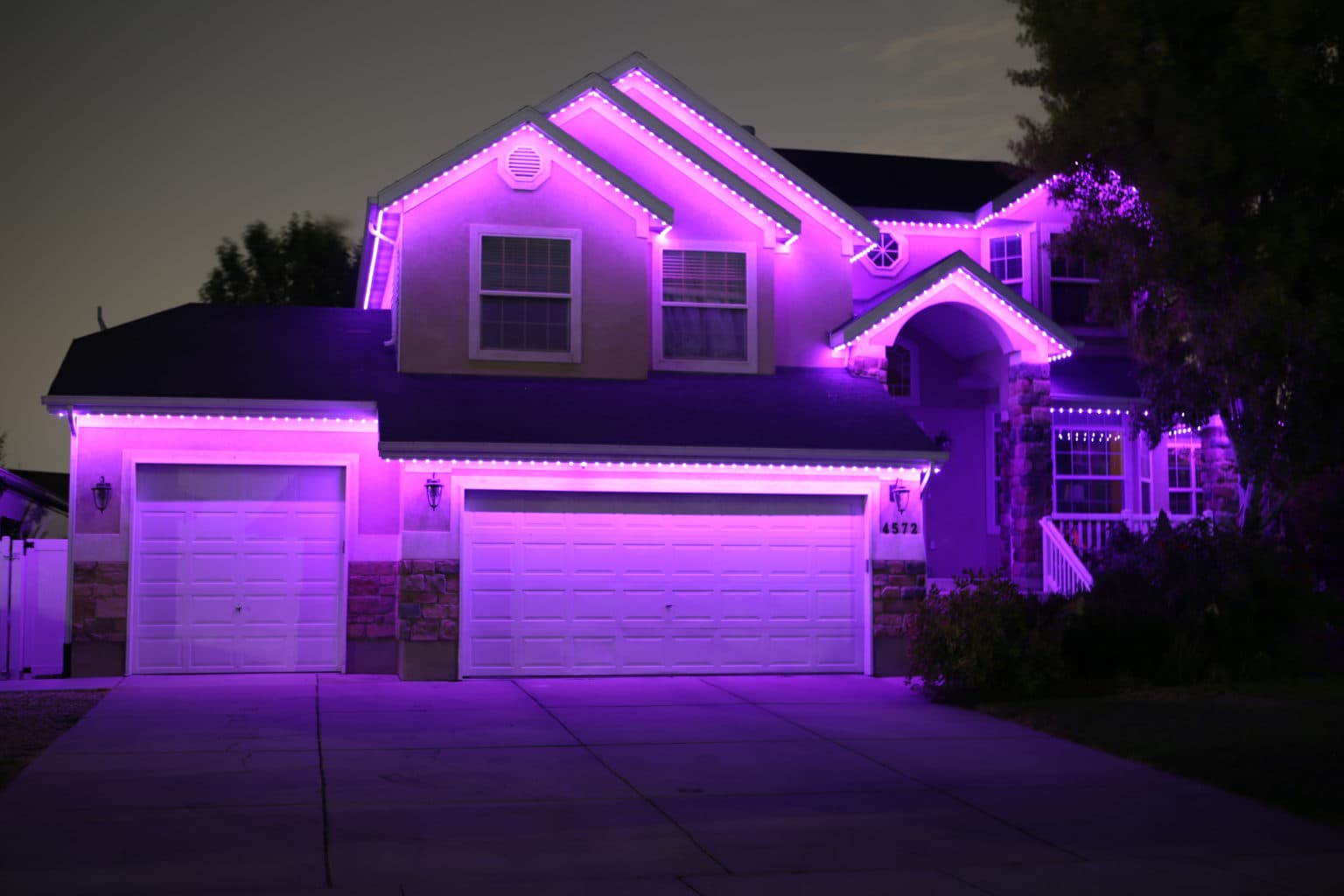 Close-up of Govee LED permanent lighting track mounted on white fascia board
