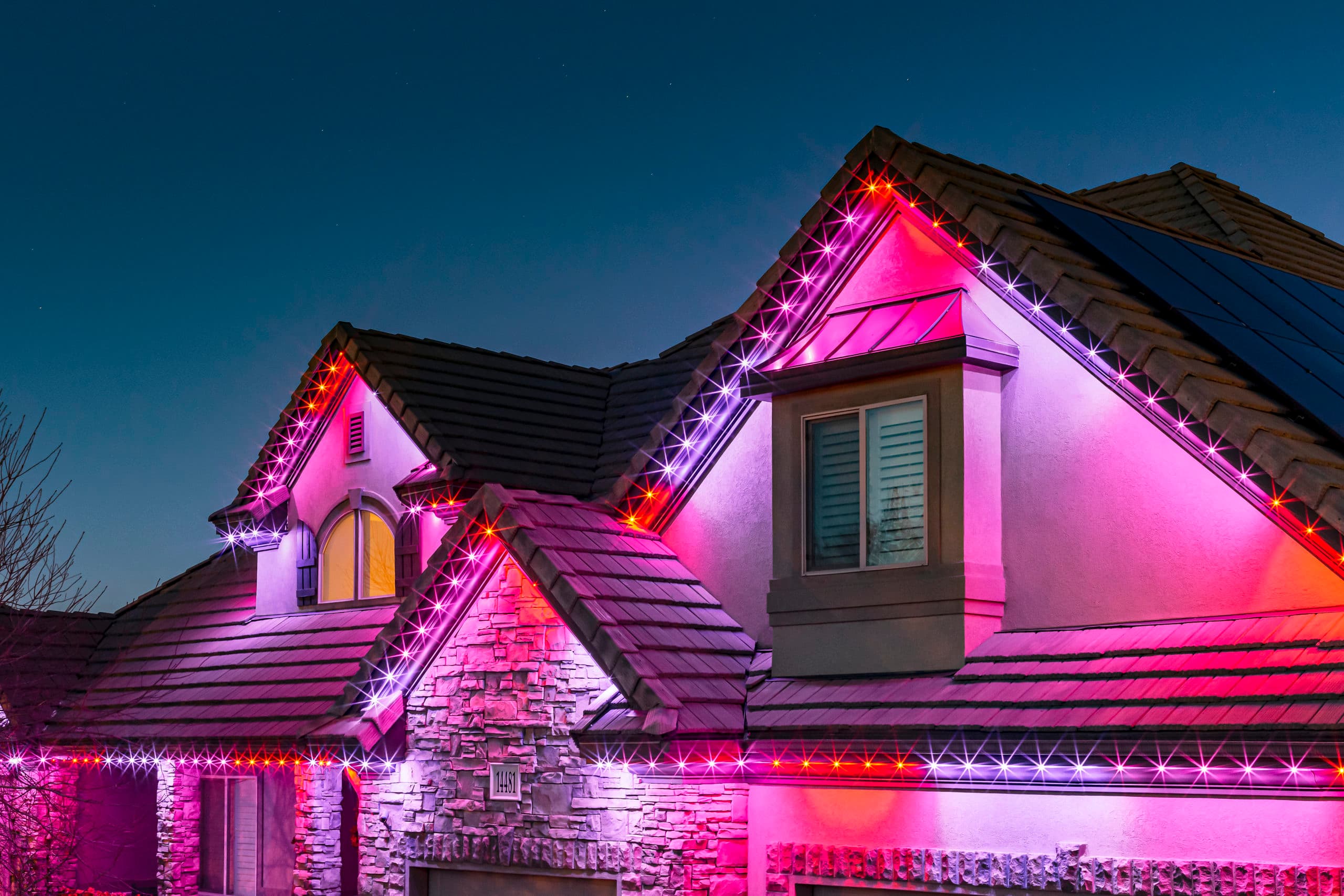 Govee permanent LED lights installed along the roofline of a home at night - We Install Govee Lights