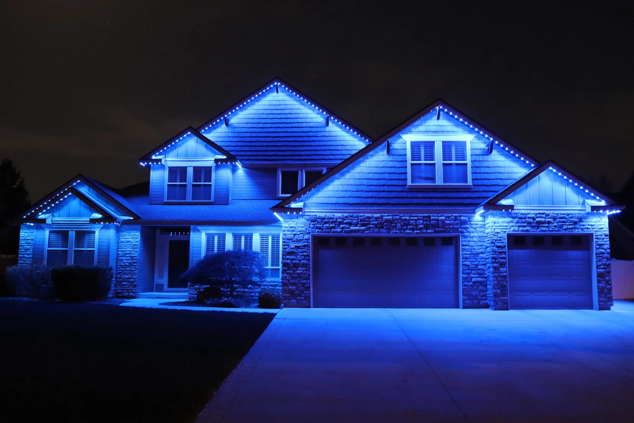 Govee permanent LED lights illuminating home exterior at night in vibrant colours - Southwestern Ontario