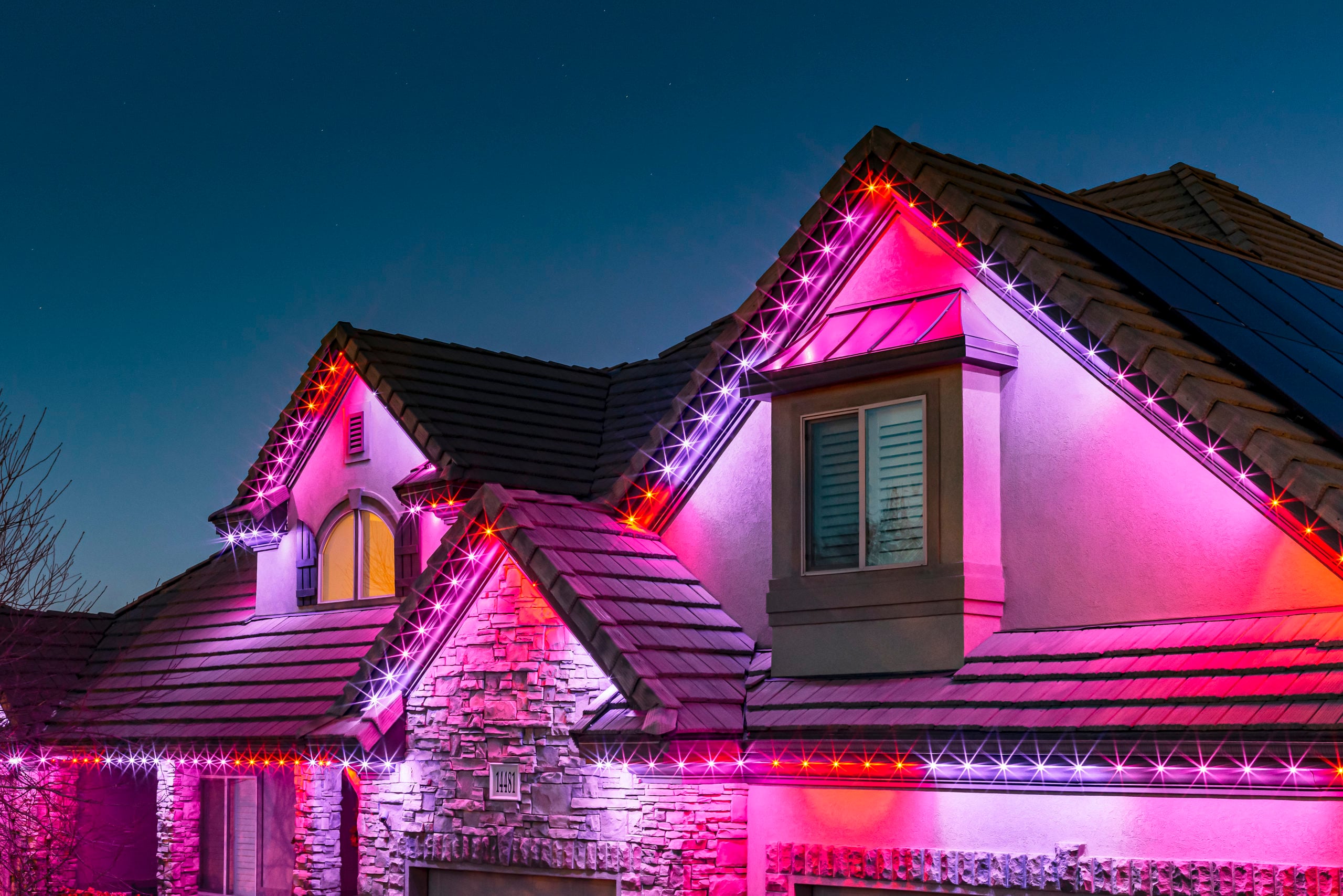 Govee permanent LED lights illuminating a home at night in vibrant purple and blue - We Install Govee Lights Ontario